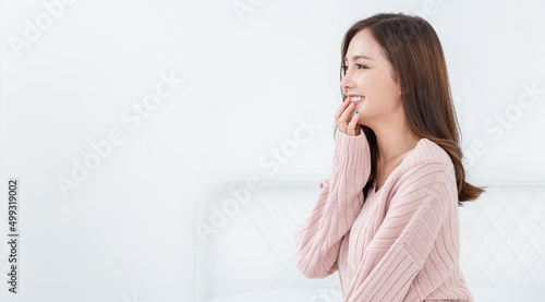 Portrait of beautiful asian woman relax face in winter bedroom. Sexy beauty girl with healthy makeup facial treatment perfect glow skin. Smile happy hygge asian korean girl isolated white background.