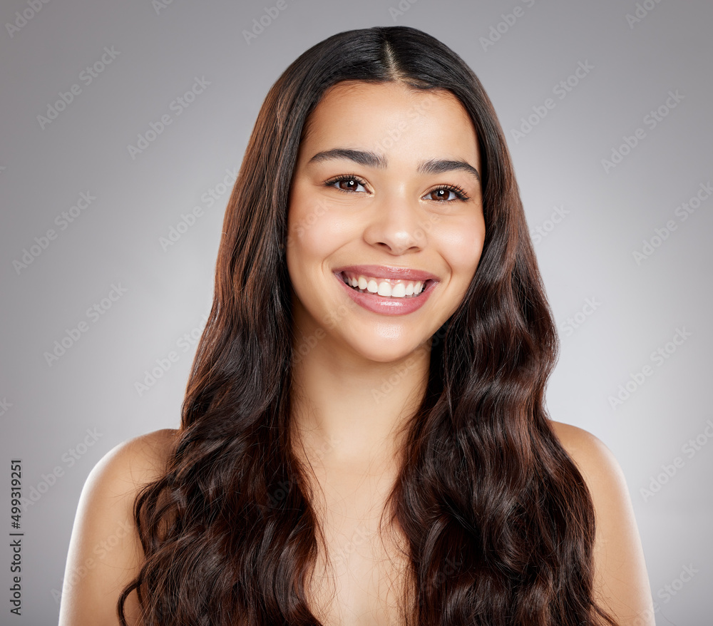 A good hair stylist is a sheer delight. Studio portrait of an attractive young woman posing against a grey background. A good hair stylist is a sheer delight. Studio portrait of an attractive young woman posing against a grey background.