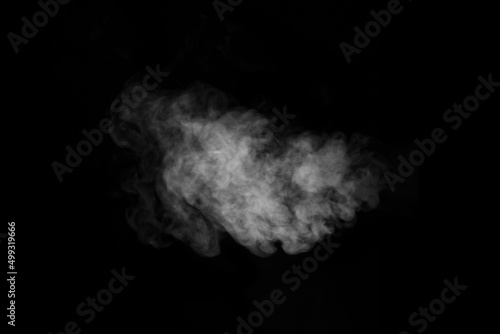Swirling, wriggling smoke, steam, isolated on a black background for overlaying on your photos. Fragment of steam.