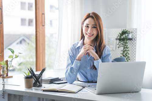 girl working at office on desk with computer graph work concept. beautiful smile