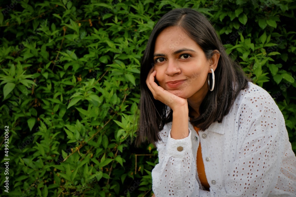 portrait of a cute indian girl with green background. portrait of a cute indian girl with green background.