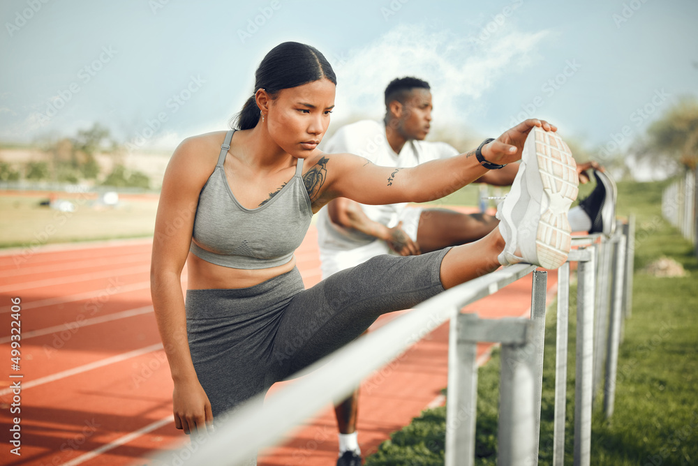 Lts stretch it out. Cropped shot of a young athletic couple warming up before starting their outdoor exercise routine.