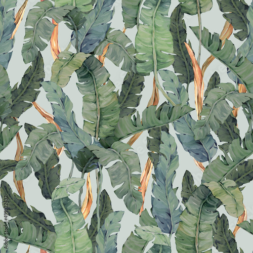 Seamless pattern with tropical green and orange leaves on a light background. Painted in watercolor. For textiles, wallpaper, wrapping paper and other types of design.