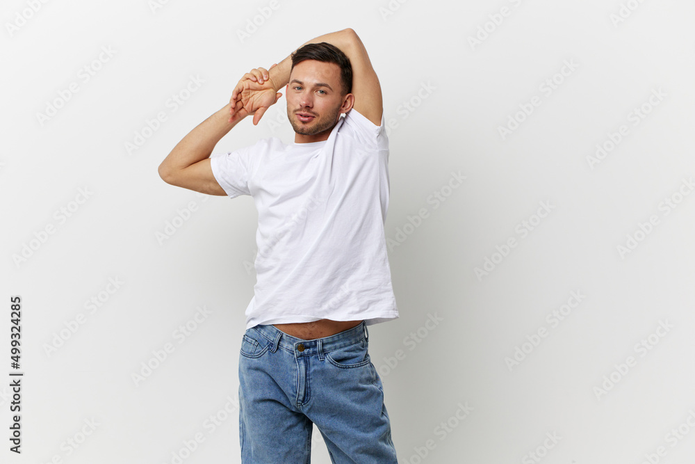 Young relaxed happy tanned handsome man in basic t-shirt folded hands overhead posing isolated on over white studio background. Copy space Banner Mockup. People emotions Lifestyle concept Young relaxed happy tanned handsome man in basic t-shirt folded hands overhead posing isolated on over white studio background. Copy space Banner Mockup. People emotions Lifestyle concept