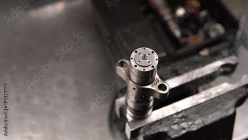 disassembling and detection of defects in parts of diesel engine nozzles. Engine injector repair. Male mechanical measuring elements nozzle caliper. Close-up fast shooting