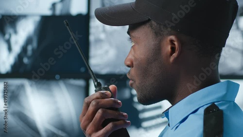 Wallpaper Mural Close up of security guard look at monitor and report on walkie talkie Torontodigital.ca