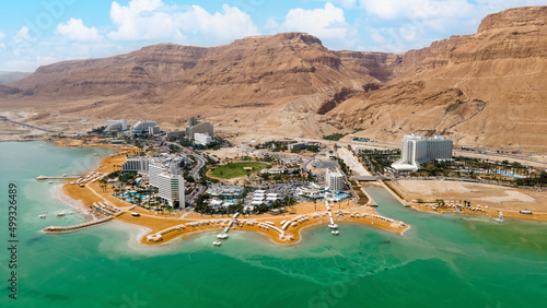 Dead sea beach shore tourist hotels, salt water, daylight Ein Bokek Panorama aerial view photo
