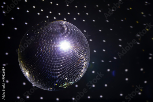 Shiny silver disco ball hanging from the ceiling