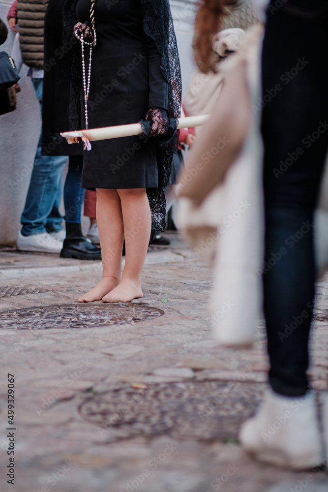 Easter week in Granada, Spain. Penitent woman walking barefoot Easter week in Granada, Spain. Penitent woman walking barefoot