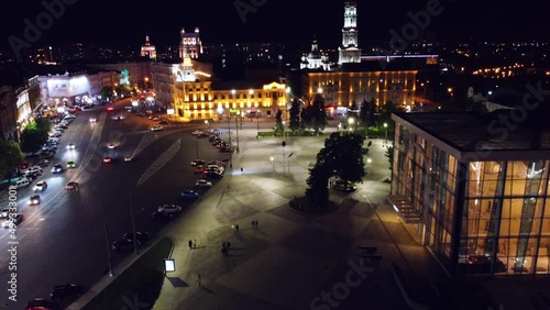 Night lights illuminated city aerial view. City center square (Maidan Konstytutsii) with Dormition Cathedral, historical museum landmarks in Kharkiv, Ukraine photo