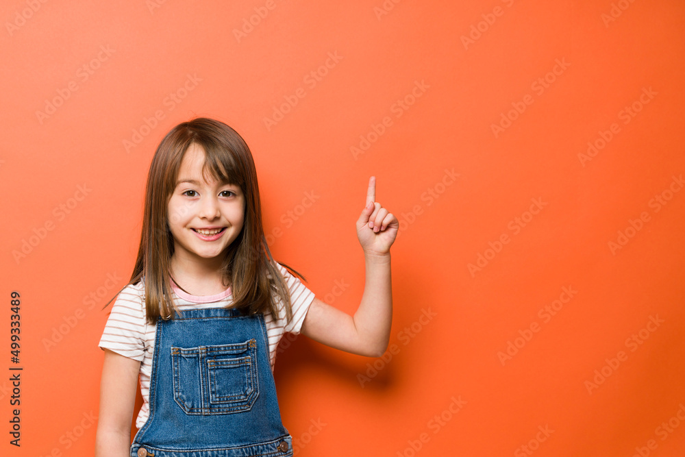 Beautiful girl pointing up to copy space Beautiful girl pointing up to copy space