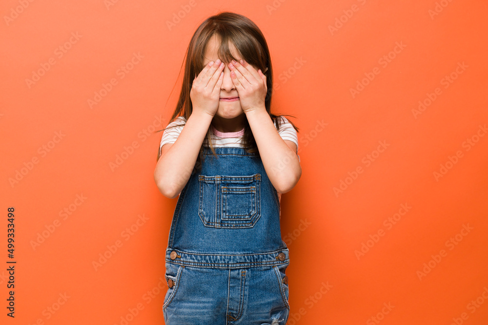 Scared little girl with eyes covered Scared little girl with eyes covered