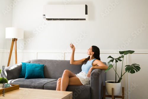 Happy woman using her new air conditioning photo