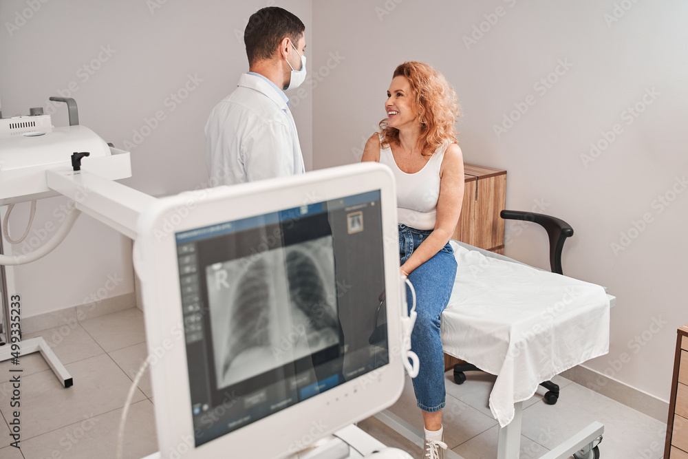 Woman discussing results of the fluorography with her male doctor at the hospital Woman discussing results of the fluorography with her male doctor at the hospital