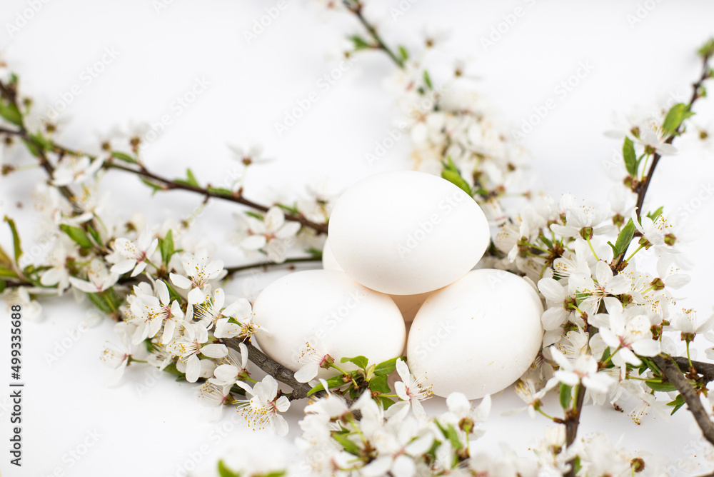 white eggs with white flowers on a white background white eggs with white flowers on a white background