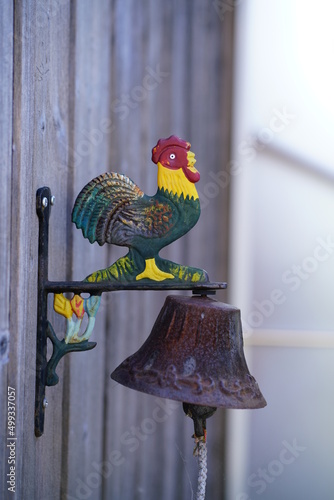 Cockerel on a bell on the walls of a swiss chalet