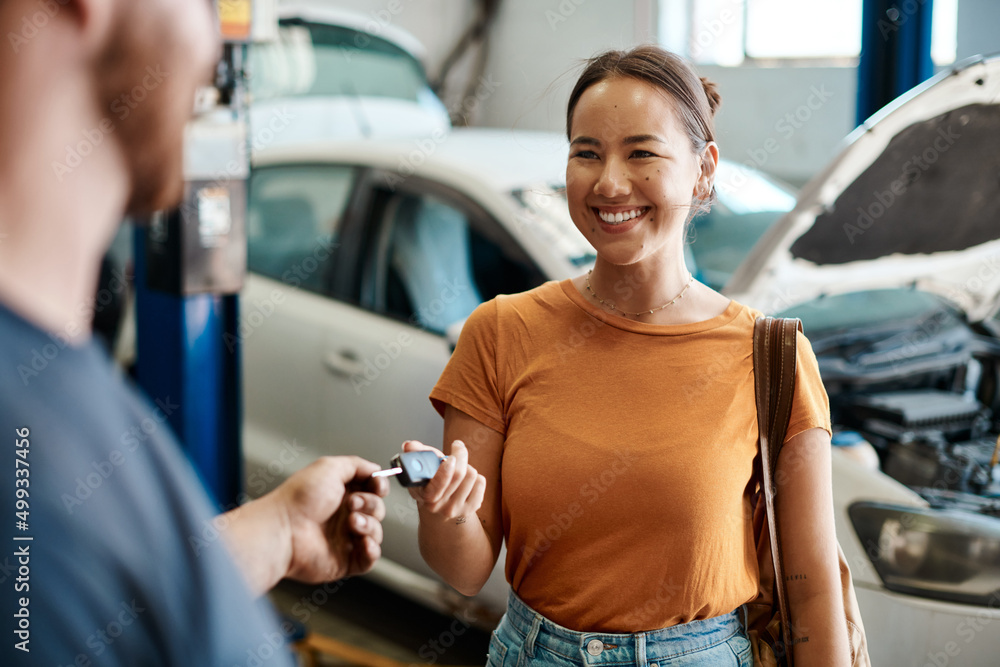 We take care of cars and the people who drive them. Shot of a woman receiving her car keys. - obrazy, fototapety, plakaty 