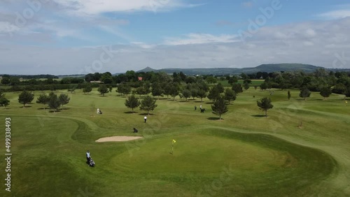4K golf course drone footage, flyover over golf course with scenic backdrop on a summers day in England. 