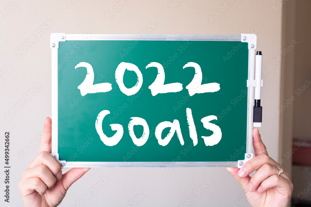 2022 goals text hand writing on chalkboard - motivation concept and strategy plan. 2022 goals text hand writing on chalkboard - motivation concept and strategy plan.