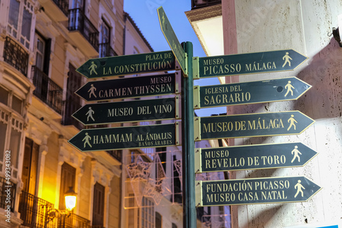 Signpost in the City Centre with directions to tourist attractions.In the evening hours.Malaga, Spain, Andalusia. photo