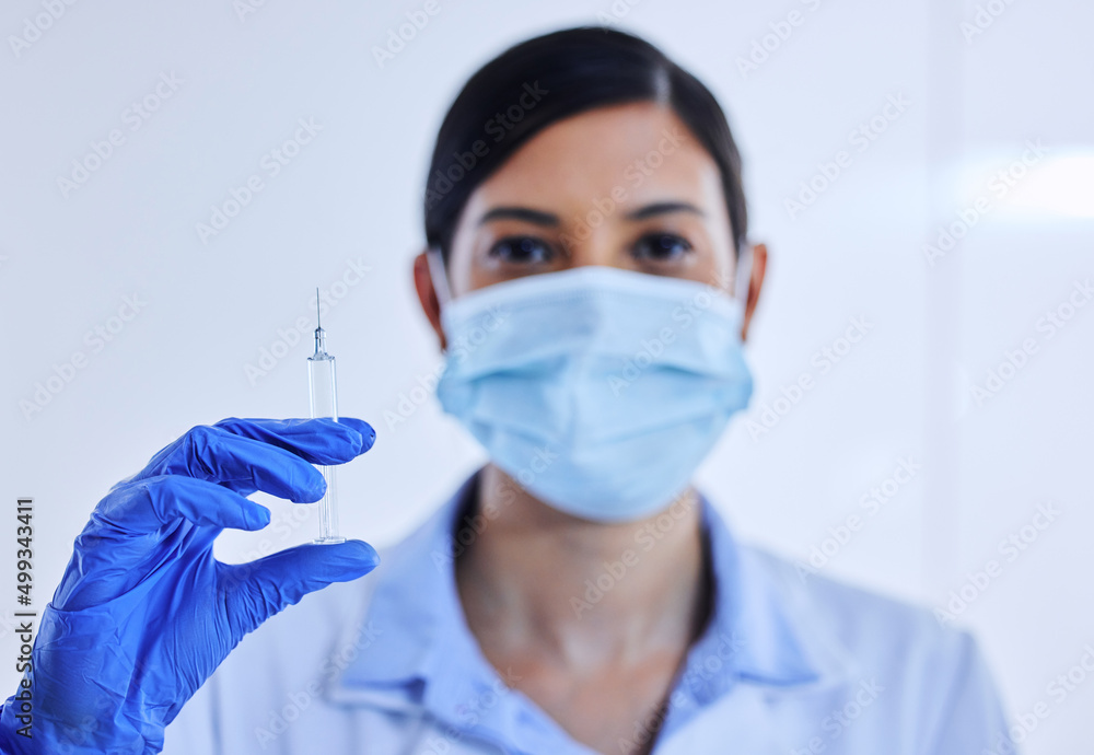 You ready. Cropped shot of an unrecognizable female scientist holding up a syringe containing medication. You ready. Cropped shot of an unrecognizable female scientist holding up a syringe containing medication.
