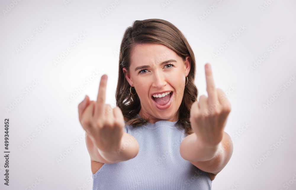 Well heres what I think. Studio portrait of a young woman showing middle finger against a grey background. Well heres what I think. Studio portrait of a young woman showing middle finger against a grey background.