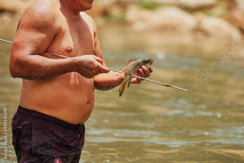 Latino men fishing in the rivers of Mexico. Artisanal fishing. Rivers of Oaxaca. Weight with harpoon.