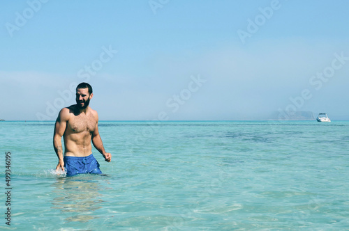 Man swimming in clear water