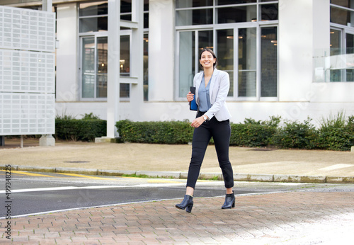 Taking strides toward my destiny. Shot of a young businesswoman enjoying a cup of coffee while making her way work.