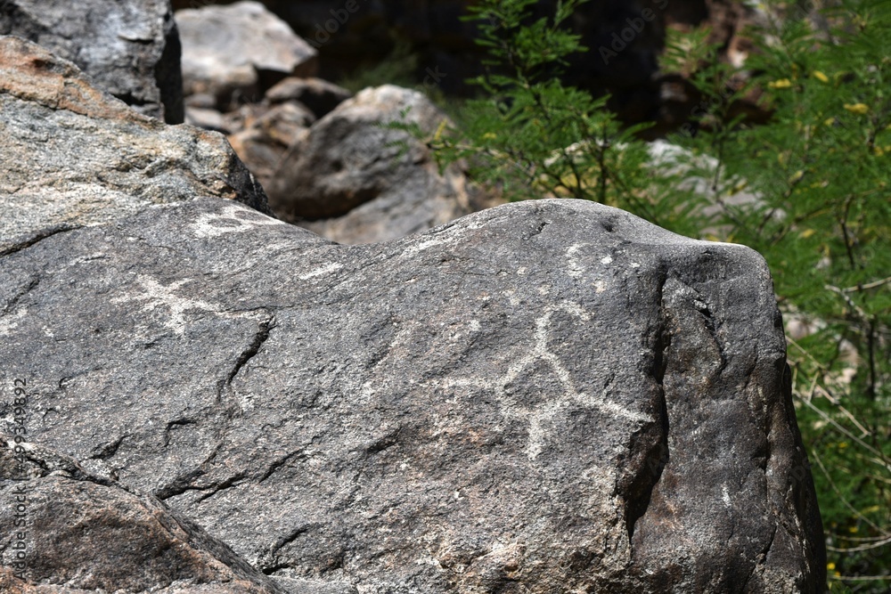 Ancient Petroglyphs etched into rock at White Tank Regional Park in Arizona Ancient Petroglyphs etched into rock at White Tank Regional Park in Arizona