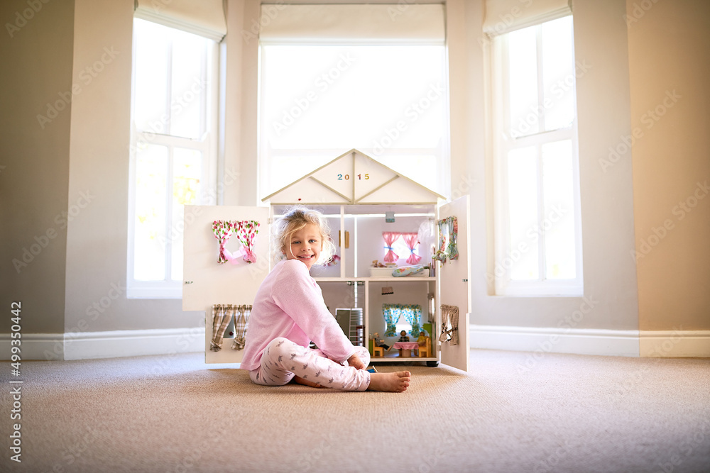 She has such a bright imagination. Portrait of a little girl playing with her dollhouse at home. She has such a bright imagination. Portrait of a little girl playing with her dollhouse at home.