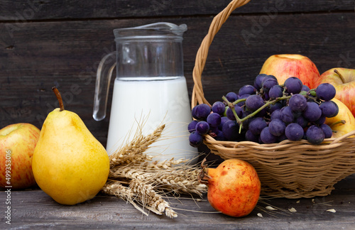 pitcher with milk, cheese wheat and fruits Shavuot concept photo