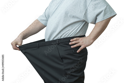 The man pulls on his big pants at the waist.