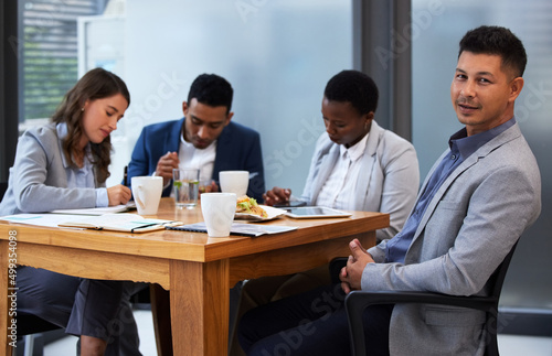 Its important that team members hear out one anothers opinions. Shot of a group of colleagues having a meeting and breakfast in a modern office.