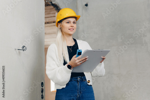 Foreman designer woman inspecting work of builder construction in apartment, checks supervision design project concept photo
