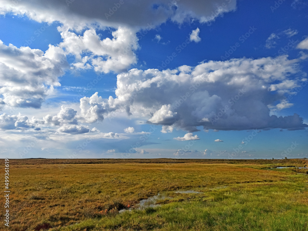 Stunning thick clouds over the tundra field water sun warmth tenderness