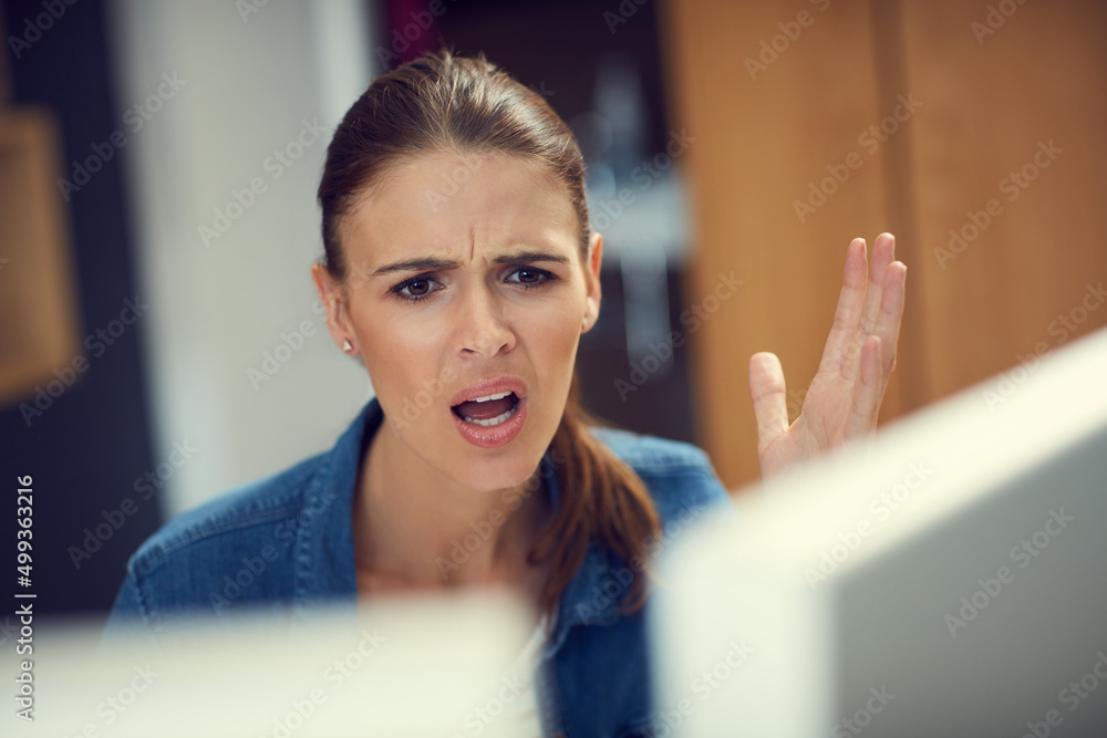 Why is the internet so slow. Shot of a young businesswoman using a computer and looking angry in a modern office. Why is the internet so slow. Shot of a young businesswoman using a computer and looking angry in a modern office.