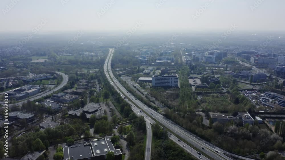 Highway traffic road near a village. Heavy traffic on highway ,fast cars traveling on the highway ,abstract speed transportation background. Top view over the highway, expressway and motorway. Highway traffic road near a village. Heavy traffic on highway ,fast cars traveling on the highway ,abstract speed transportation background. Top view over the highway, expressway and motorway.