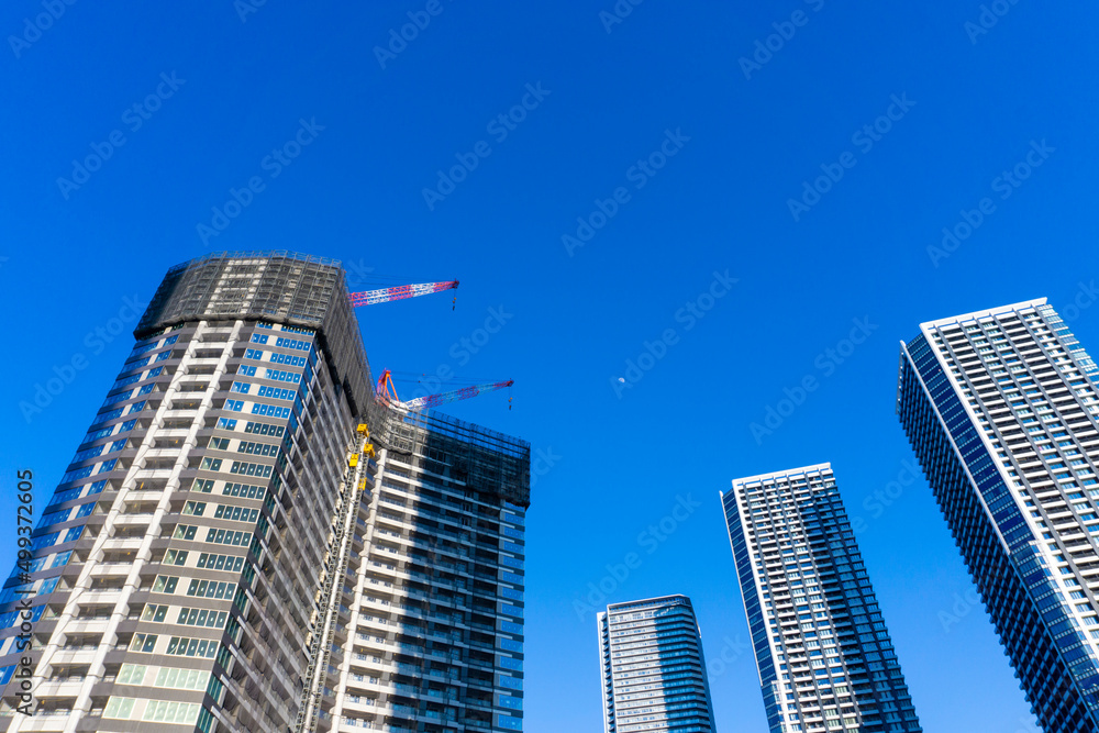 Tower condominium under construction and large crane