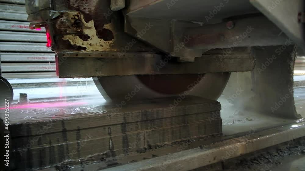 Huge round electric saw cutting the ferroconcrete plate easily. Equipment at modern construction plant. Close up. Huge round electric saw cutting the ferroconcrete plate easily. Equipment at modern construction plant. Close up.