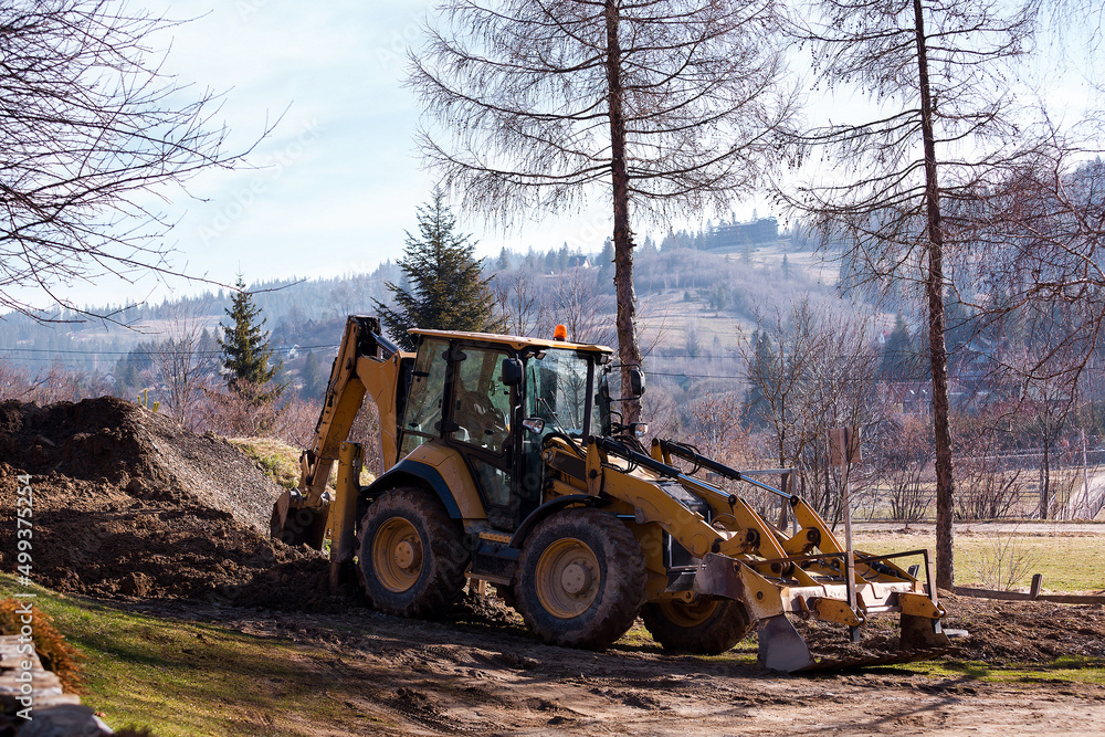 Wheel excavator loader is digging the soil at the construction site. Wheel excavator loader is digging the soil at the construction site.