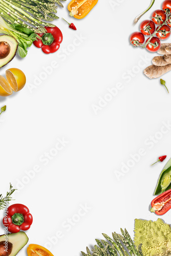 Various vegetables frame with bell pepper, asparagus, tomatoes, ginger, lemon, avocado and chili. Healthy food background on white background. Top view with copy space.