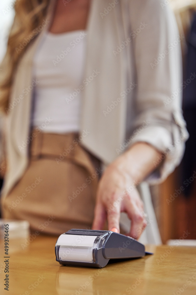 Spending some hard earned cash. Shot of a woman using her bank card to pay for a purchase in a store. Spending some hard earned cash. Shot of a woman using her bank card to pay for a purchase in a store.