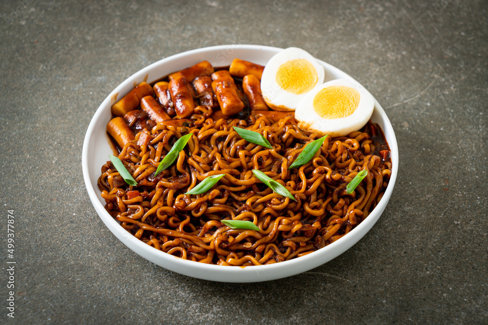 Jjajang Rabokki - Korean instant noodles or Ramyeon with Korean rice cake or Tteokbokki and egg in black bean sauce Jjajang Rabokki - Korean instant noodles or Ramyeon with Korean rice cake or Tteokbokki and egg in black bean sauce