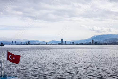 City view of Izmir from ferryboat. Cold grey winter Aegean sea. photo