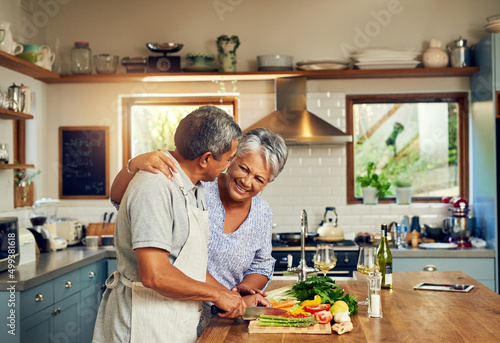 Home cooked happiness. Shot of a happy mature couple cooking a meal together at home.