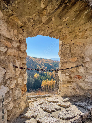 Fototapeta Naklejka Na Ścianę i Meble -  ruins of an ancient castle with old rusty chain through the hole in wall, Slovakia 