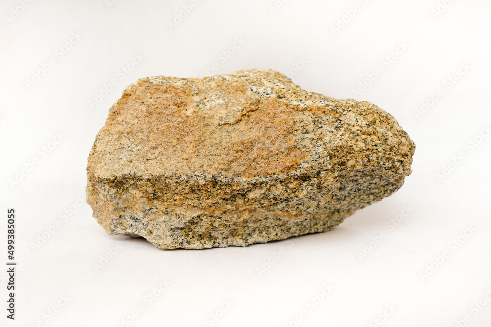 Macro shooting of raw specimen biotite granite gneiss rock isolated on white background.