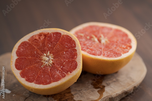 Ripe grapefruit on wood board closeup