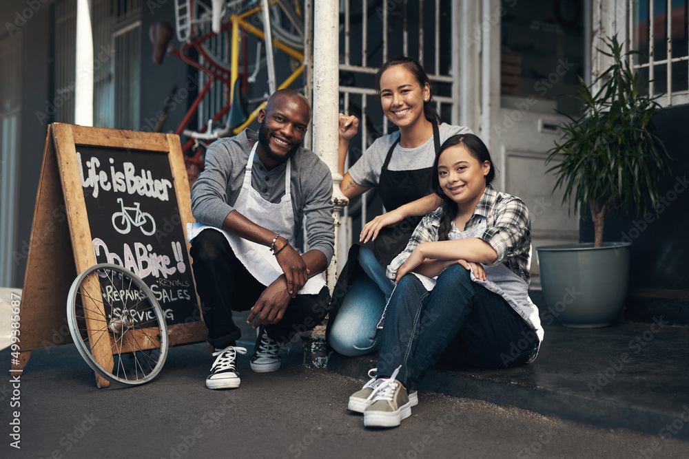 We got what you want. Portrait of three young workers sitting outside of their bicycle repair shop. We got what you want. Portrait of three young workers sitting outside of their bicycle repair shop.